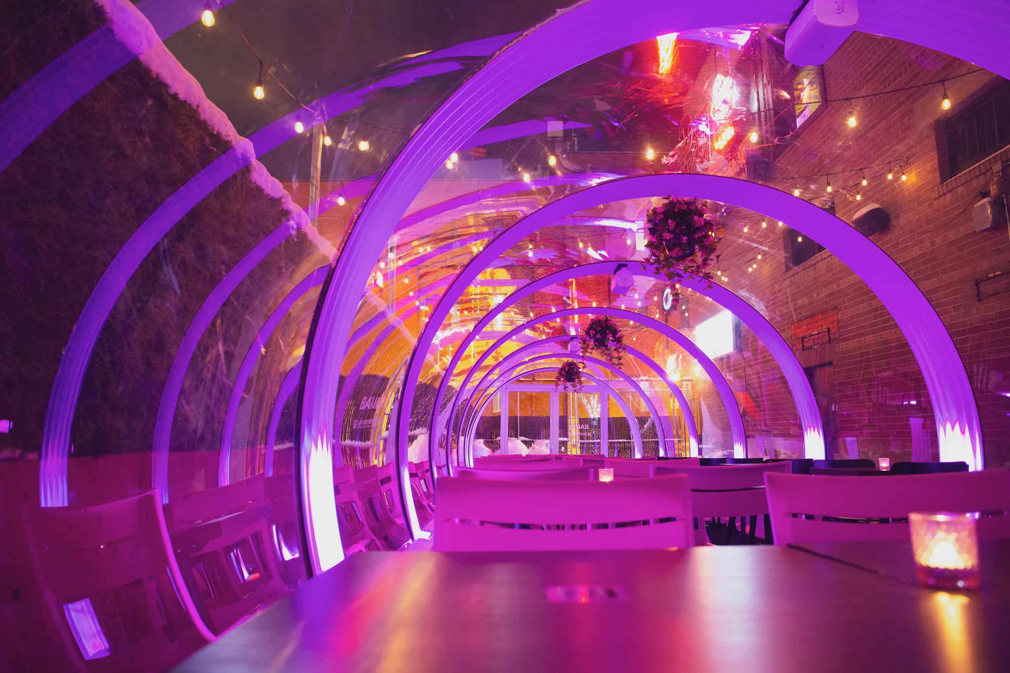 Stylish patio featuring vibrant purple neon lights and modern decor, perfect for relaxing outdoor gatherings in Canada.