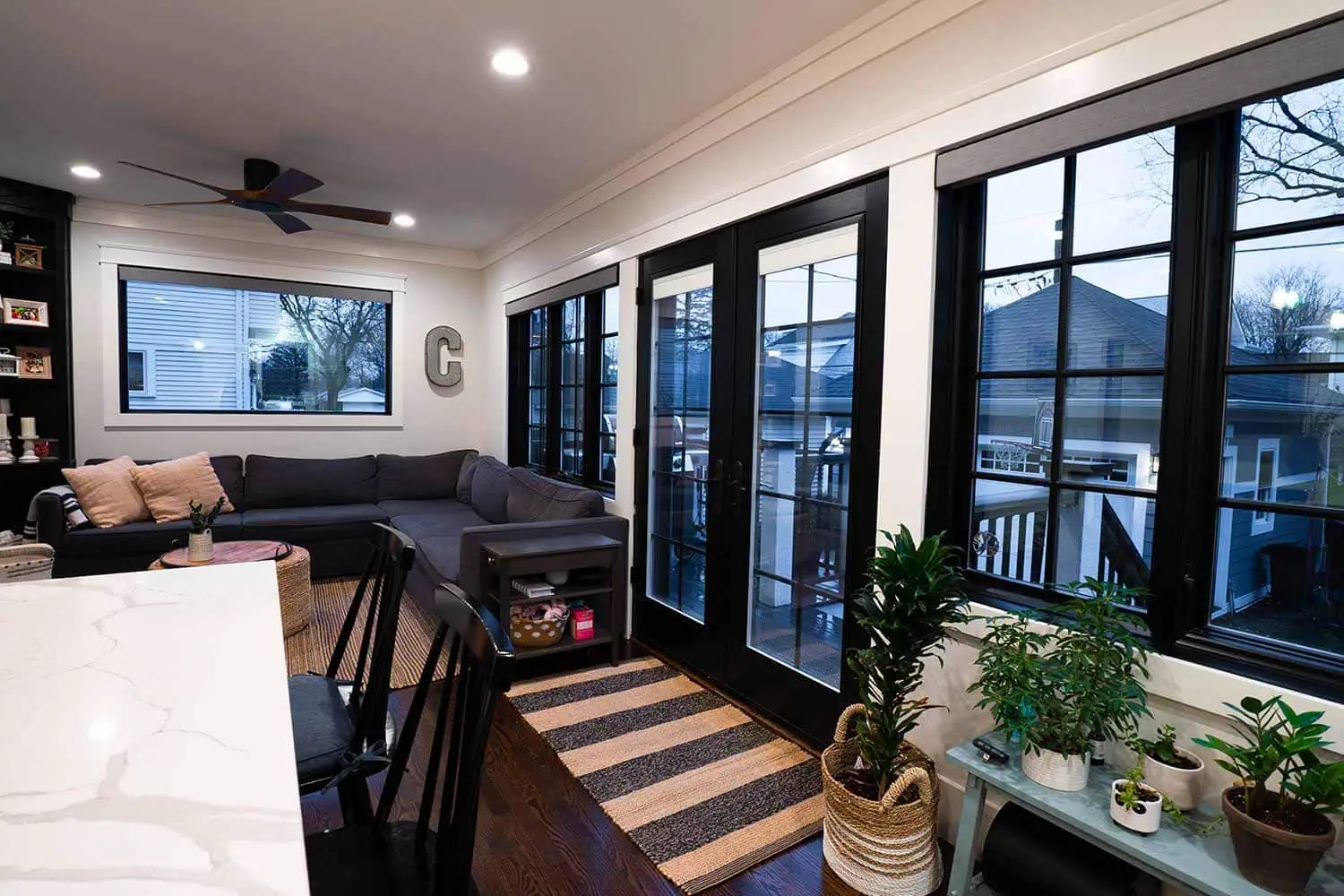 Family room home addition opens out onto deck by Elik Homes.