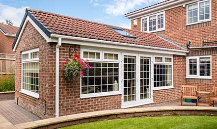 One-story brick home addition with French doors built by Elik.