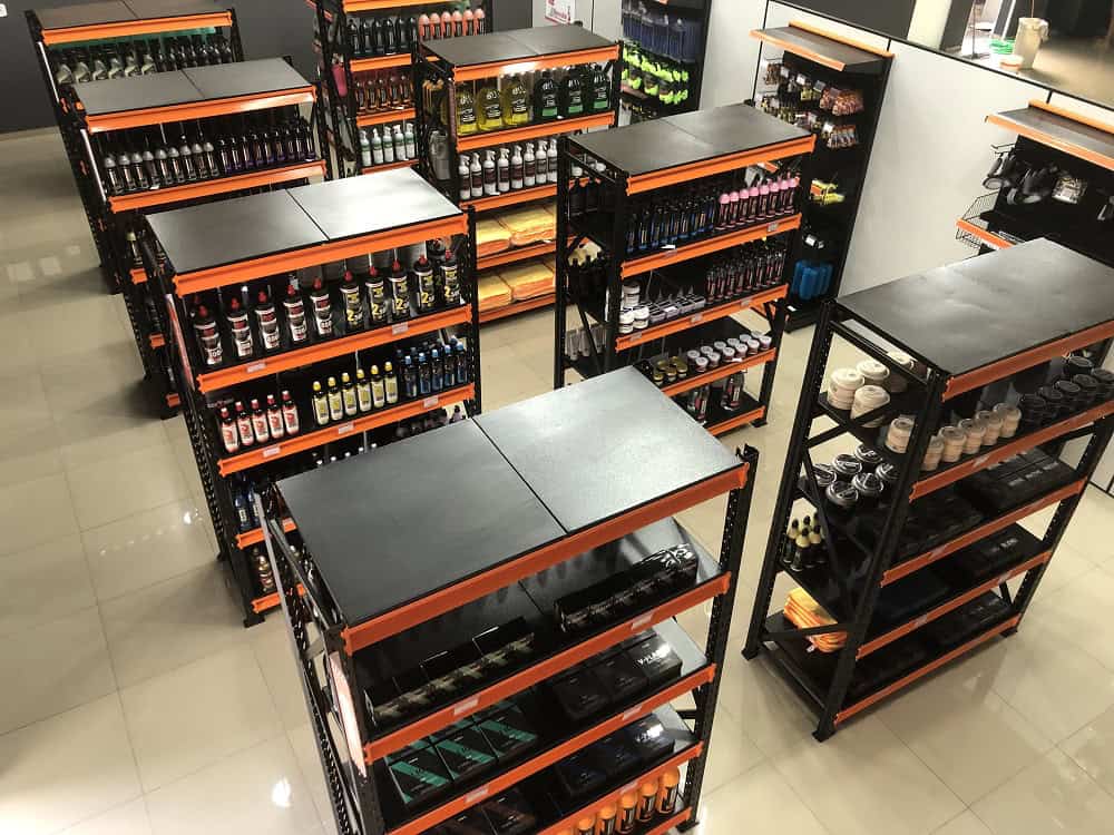 Prateleira preta com diversos produtos de limpeza. Ilustração do texto sobre franquia de produtos de limpeza.