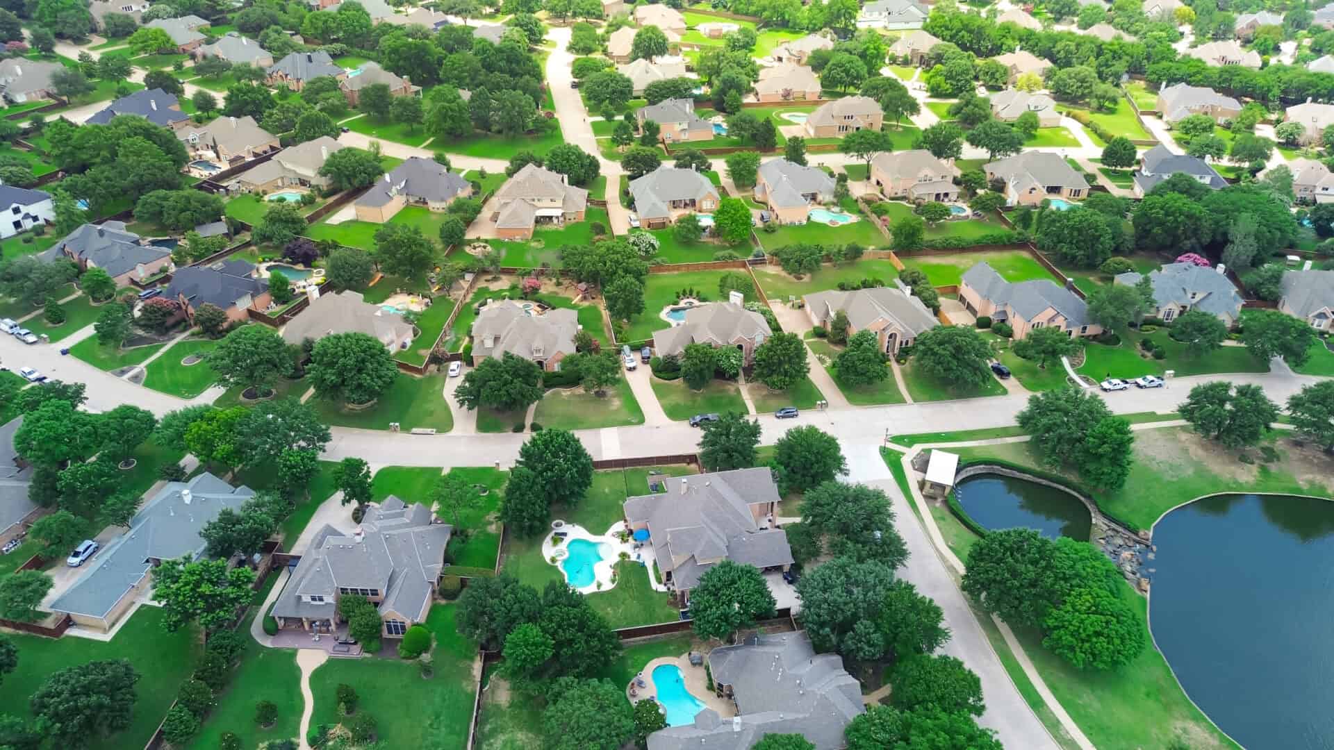 Lakeside upscale residential neighborhood with expensive two story suburban single-family home in large lot backyard, swimming pool, Southlake, suburbs Dallas Fort Worth metro, aerial view, Texas