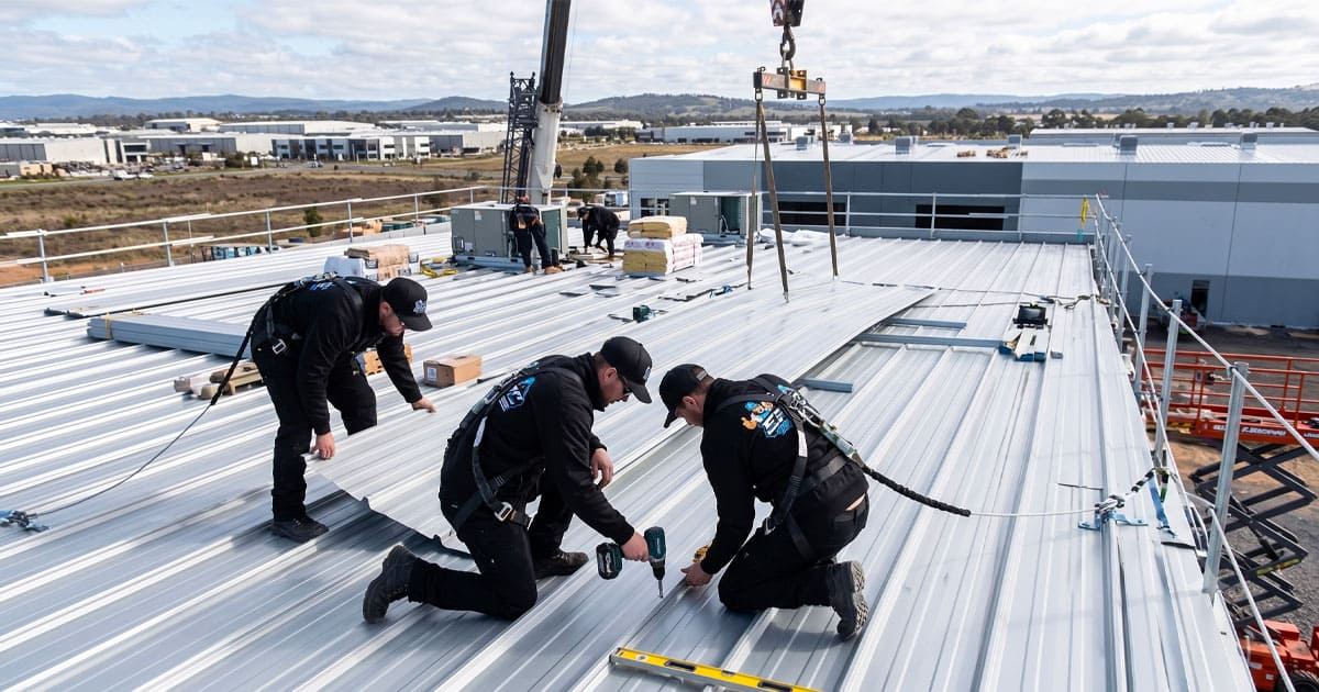 Workers installing a commercial flat roofing system