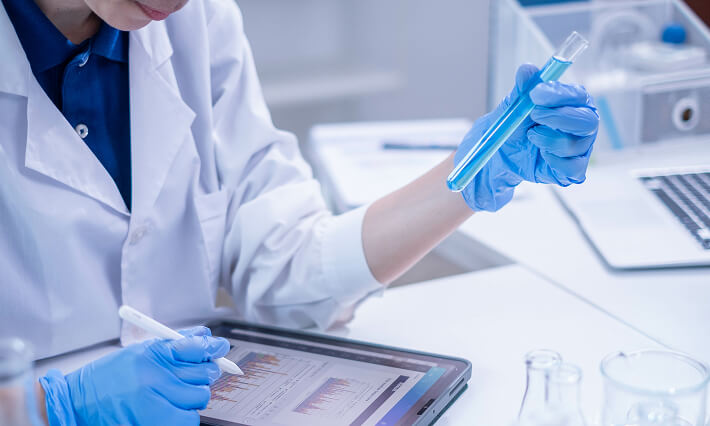 A scientist documents study data in a modern laboratory.