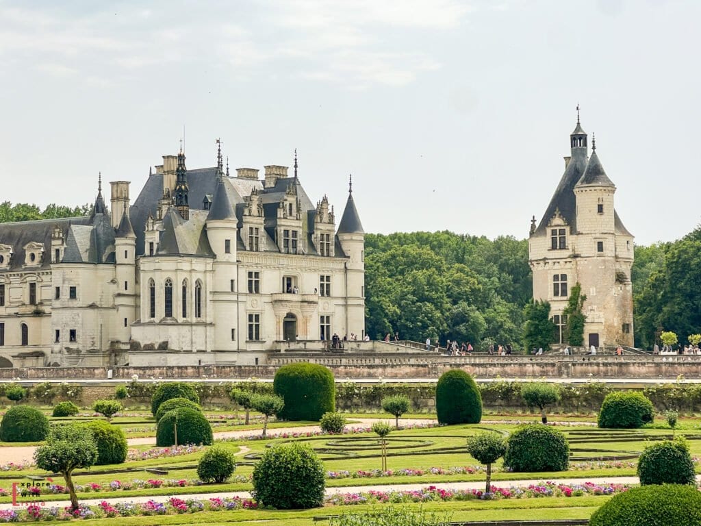 Wide view of Château de Chenonceau with its iconic turreted towers and Renaissance architecture, seen behind the formal, symmetrical layout of Diane de Poitiers' Garden, filled with manicured hedges, flowerbeds, and gravel paths.This is Diane de Poitiers’ Garden, right in front of the castle. It’s super symmetrical and perfectly kept—one of the best views of the château from here.