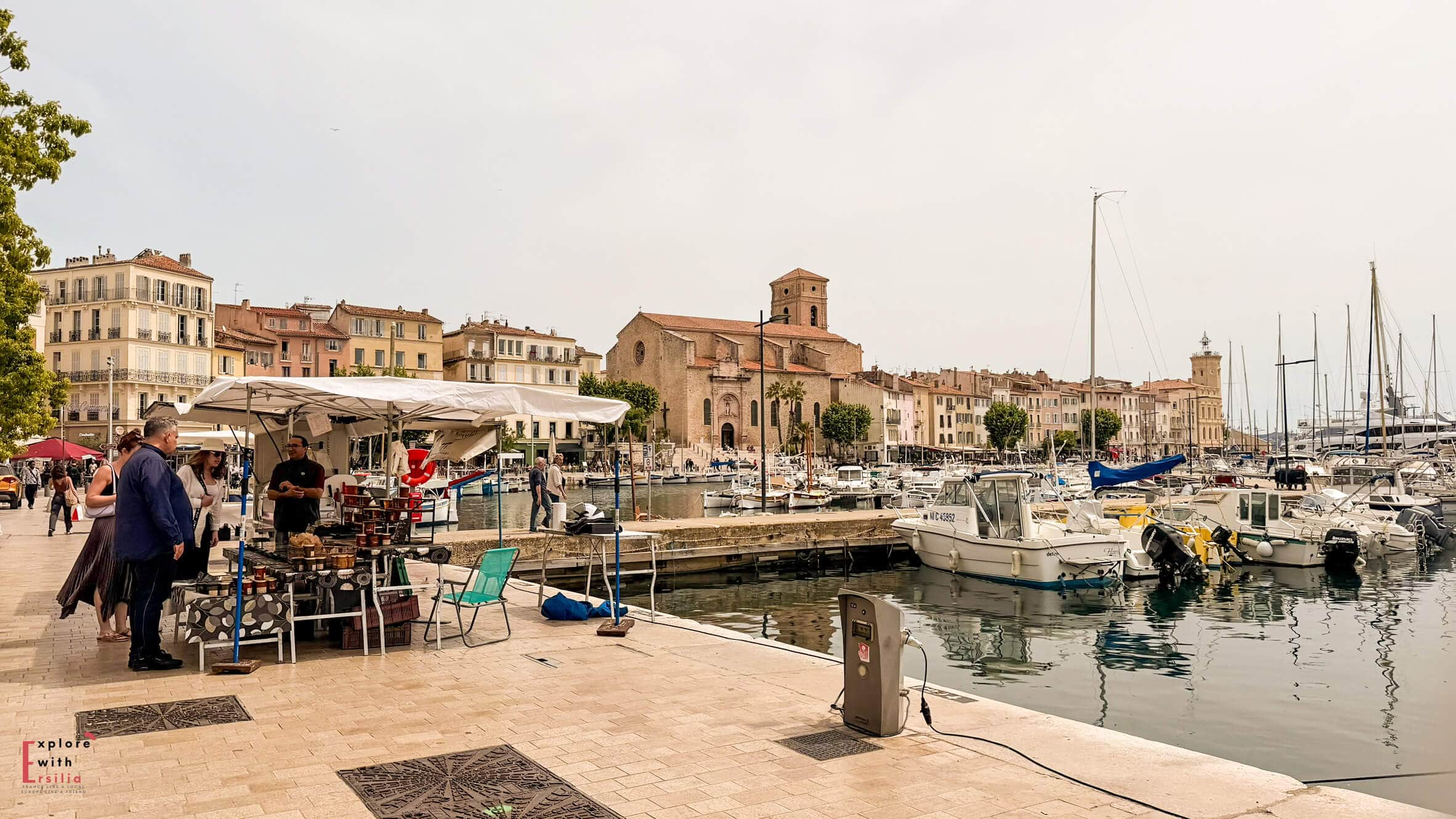 Harbor scene in La Ciotat with boats, waterfront cafés, and historic buildings along the marina.