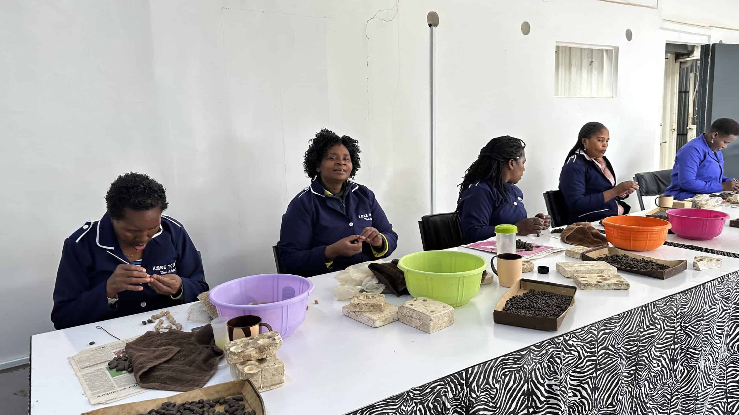 Women cutting the clay into beads