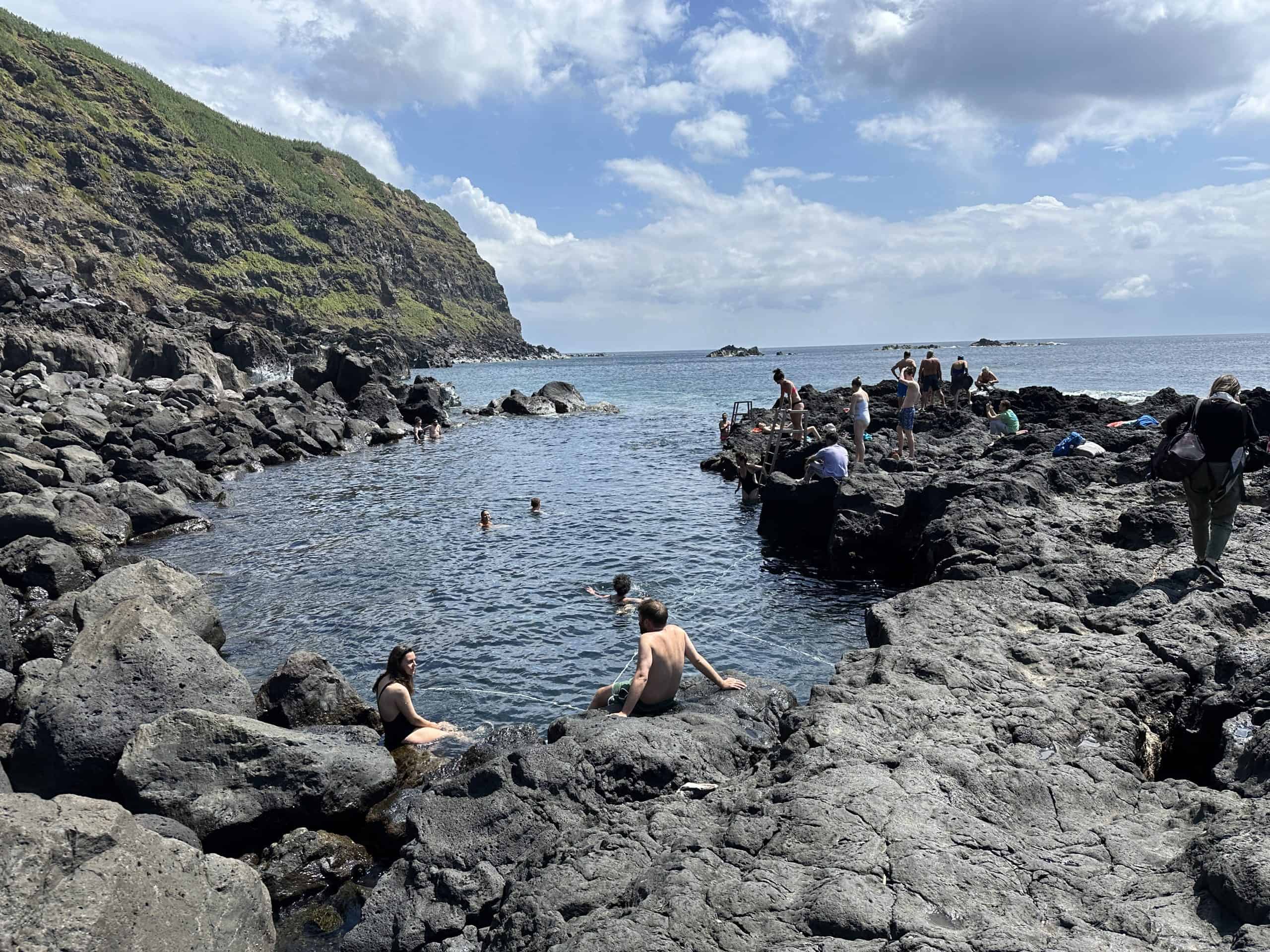 People lounging around the thermal pool