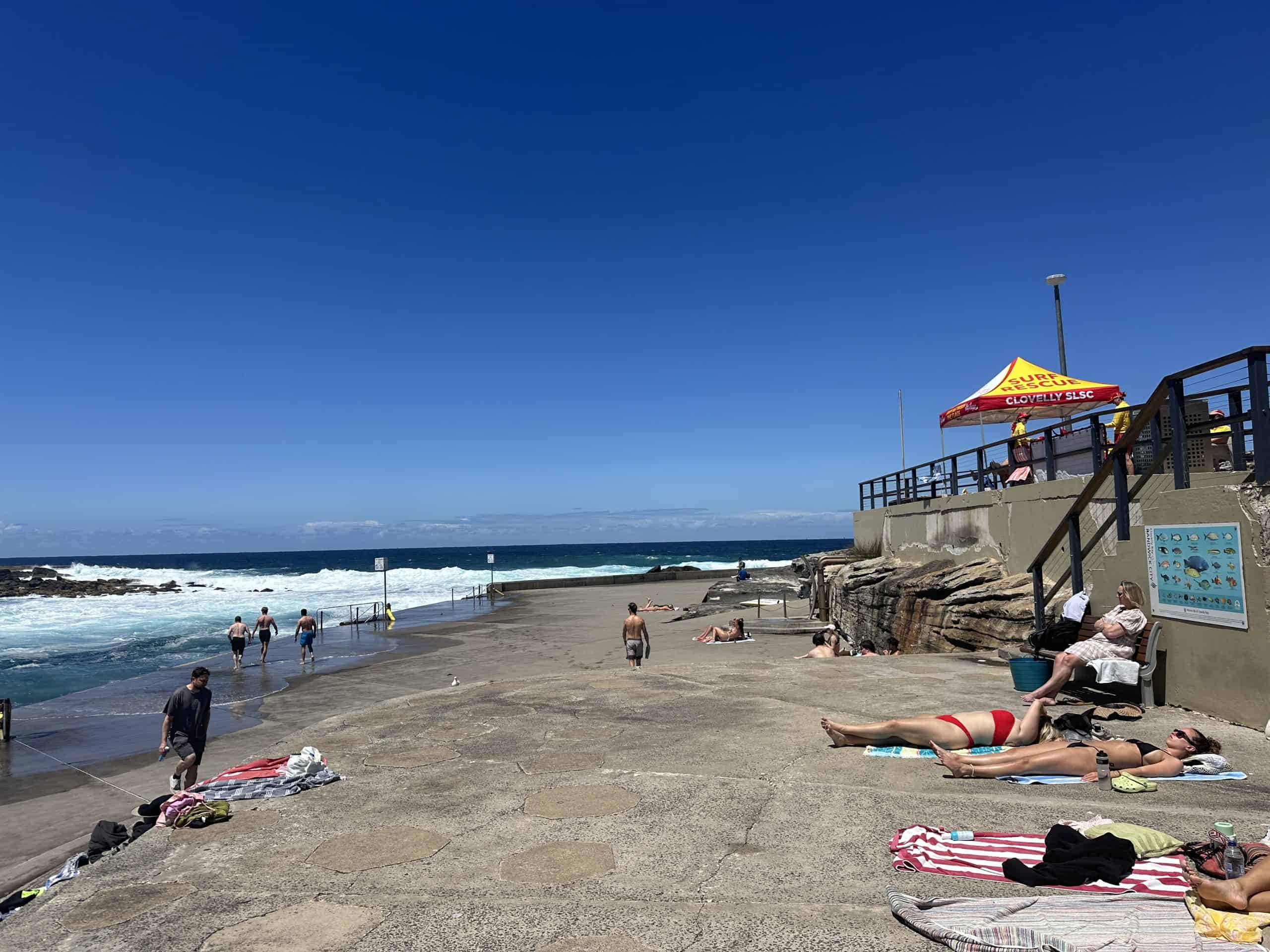 Sunbathers on the concrete surface at Clovelly Beach