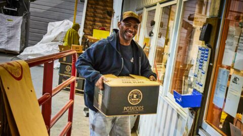 A & L Potato Co. – Man carrying a box of packaged potatoes