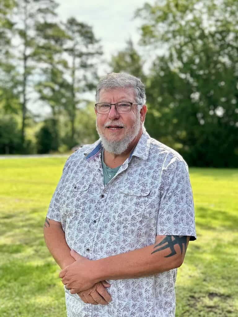Profile of Randy Sutherland on a green lawn