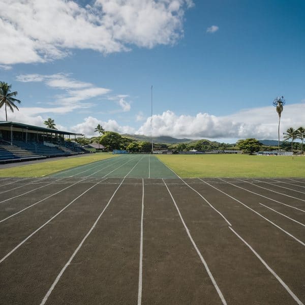 Fiji track and field stadium with running lanes and scenic background.
