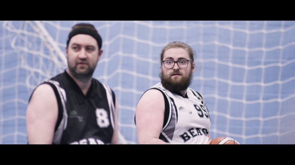 Basketball players in uniform during a game at the Film Division.