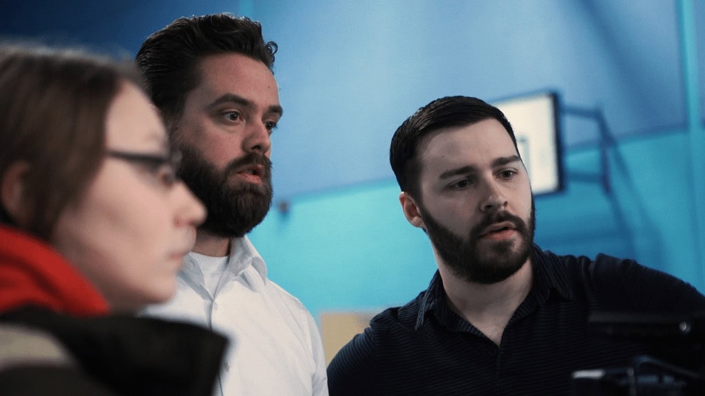 Thoughtful team discussion during film production at Film Division, showcasing behind-the-scenes of professional filmmaking.