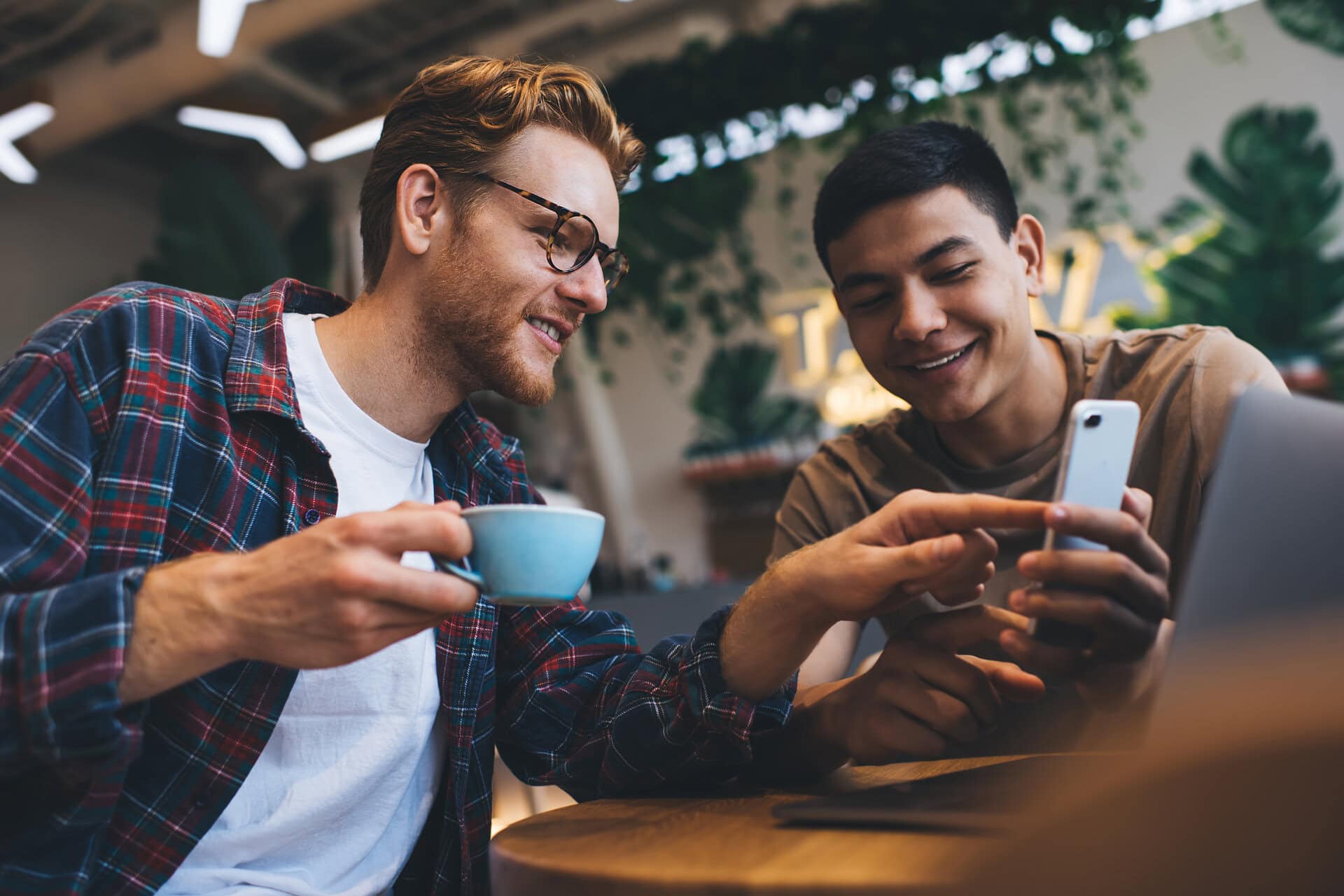 Two marketing executives look at video marketing statistics over coffee