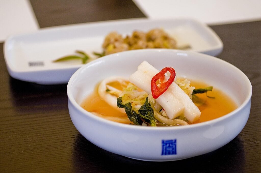 Traditional Korean radish water kimchi, Dongchimi, with a clear and refreshing cold broth.