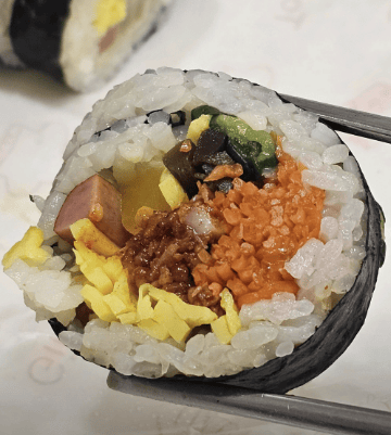 Unique Korean Kimbap filled with chewy, sweet-and-spicy seasoned dried squid (Jinmiche).