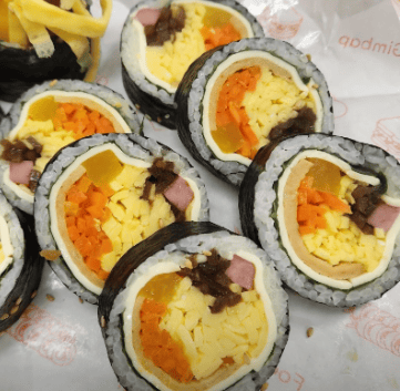 Creamy and savory Korean Cheese Kimbap filled with soft cheese and colorful vegetables.