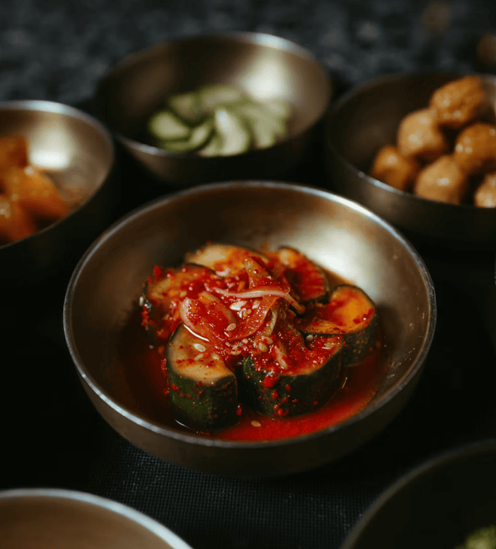 Crunchy Korean cucumber Kimchi (Oi-sobagi) stuffed with spicy chive seasoning and red chili flakes.