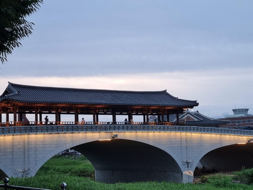 The scenic view of Namcheon-gyo Bridge with a traditional Korean pavilion (Cheong-yeon-ru) in Jeonju Hanok Village.
