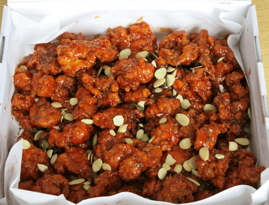 Sokcho's famous Dak-gangjeong (Sweet and sour crunchy chicken) glazed with shiny sauce and topped with crushed nuts.