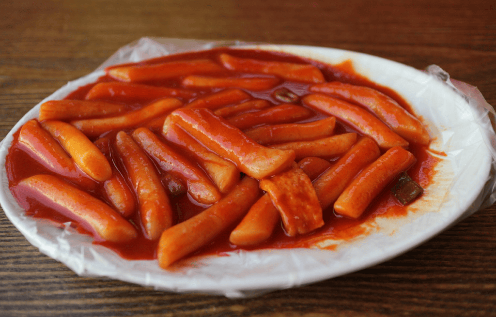 Delicious Korean Tteokbokki (Spicy rice cakes) simmered in a vibrant, sweet and spicy red chili sauce.
