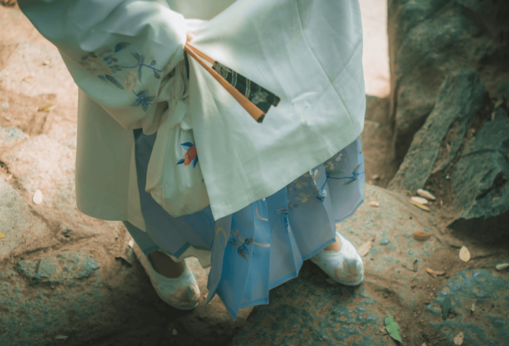 Traditional Korean embroidered flower shoes (Kkotsin) worn with a colorful Hanbok. A beautiful display of Korean craftsmanship and feminine elegance in traditional fashion.