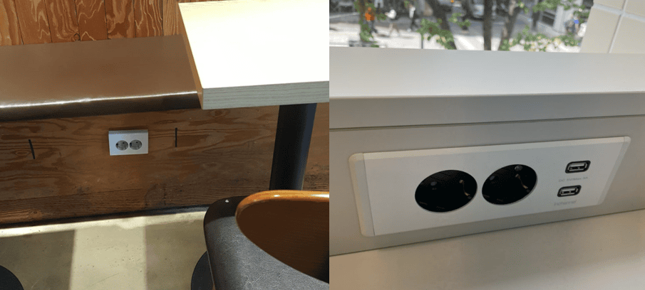Different types of power outlets in a cafe: under the seat near the floor and integrated into the table surface.
