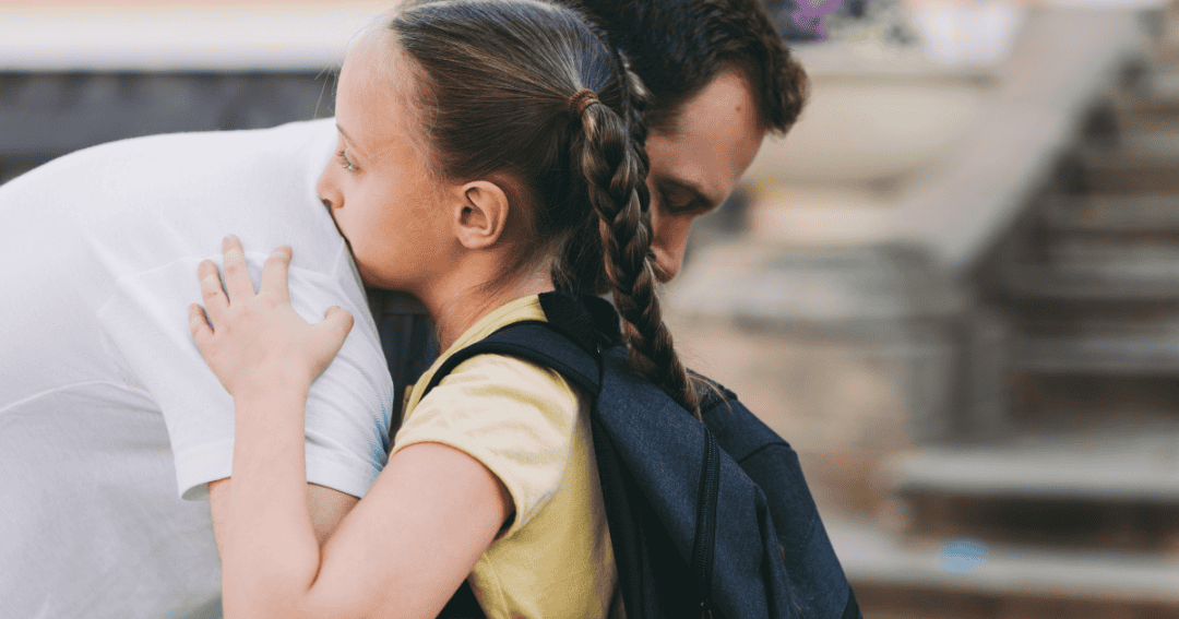 father comforting daughter after school