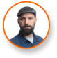 Jason Matlock, Ph.D., expert in cannabis lighting technology, wears flat cap.