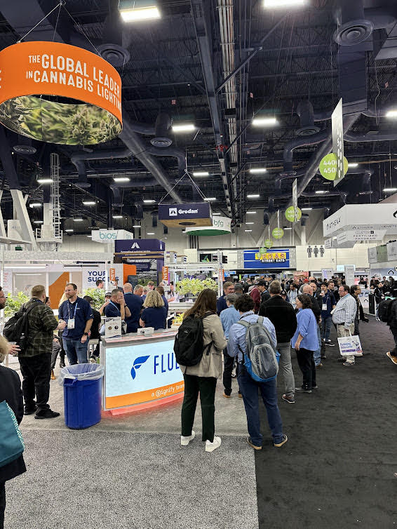 Attendees view LED grow lights for cannabis at a commercial cultivation trade show.