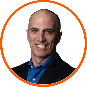 Smiling man in blue shirt, black blazer; expert in cannabis LED grow lights.