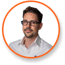 Portrait of man in glasses, trimmed beard, white shirt, with orange border; expert in LED cannabis grow lights technology.