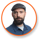 Bearded man in gray flat cap and blue shirt, expert in cannabis LED grow lights, with orange border.