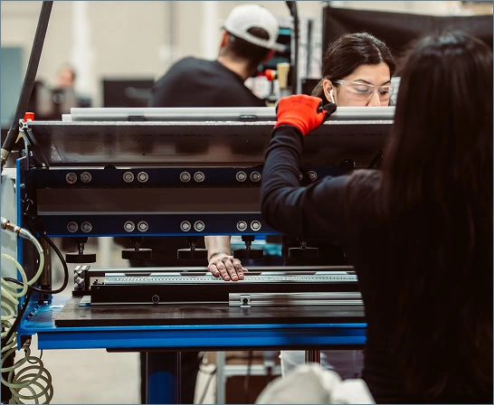 Technicians adjust industrial cannabis lighting technology at Fluence Research lab.