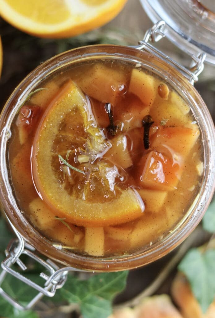 A jar of sweet preserved chicken of the woods mushroom dessert with oranges, lemon, rosemary, cinnamon and cloves