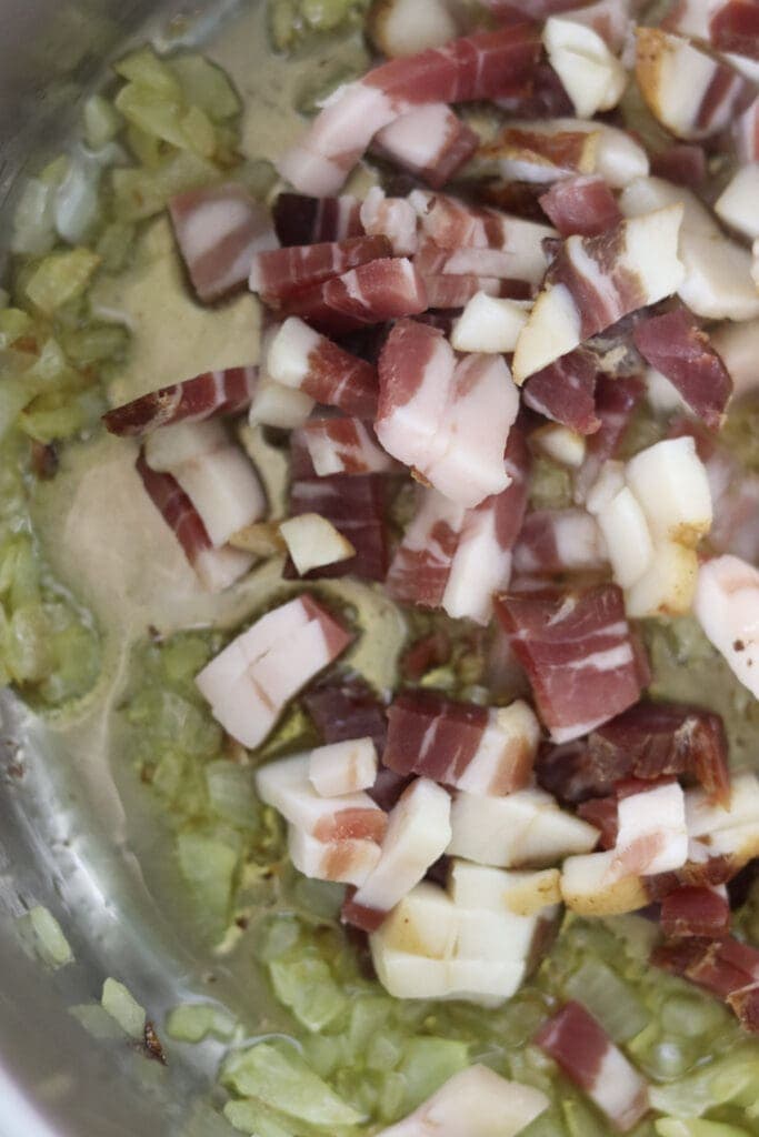 How to quickly fry the bacon, sliced into small pieces on top of onions to fully release their flavors.