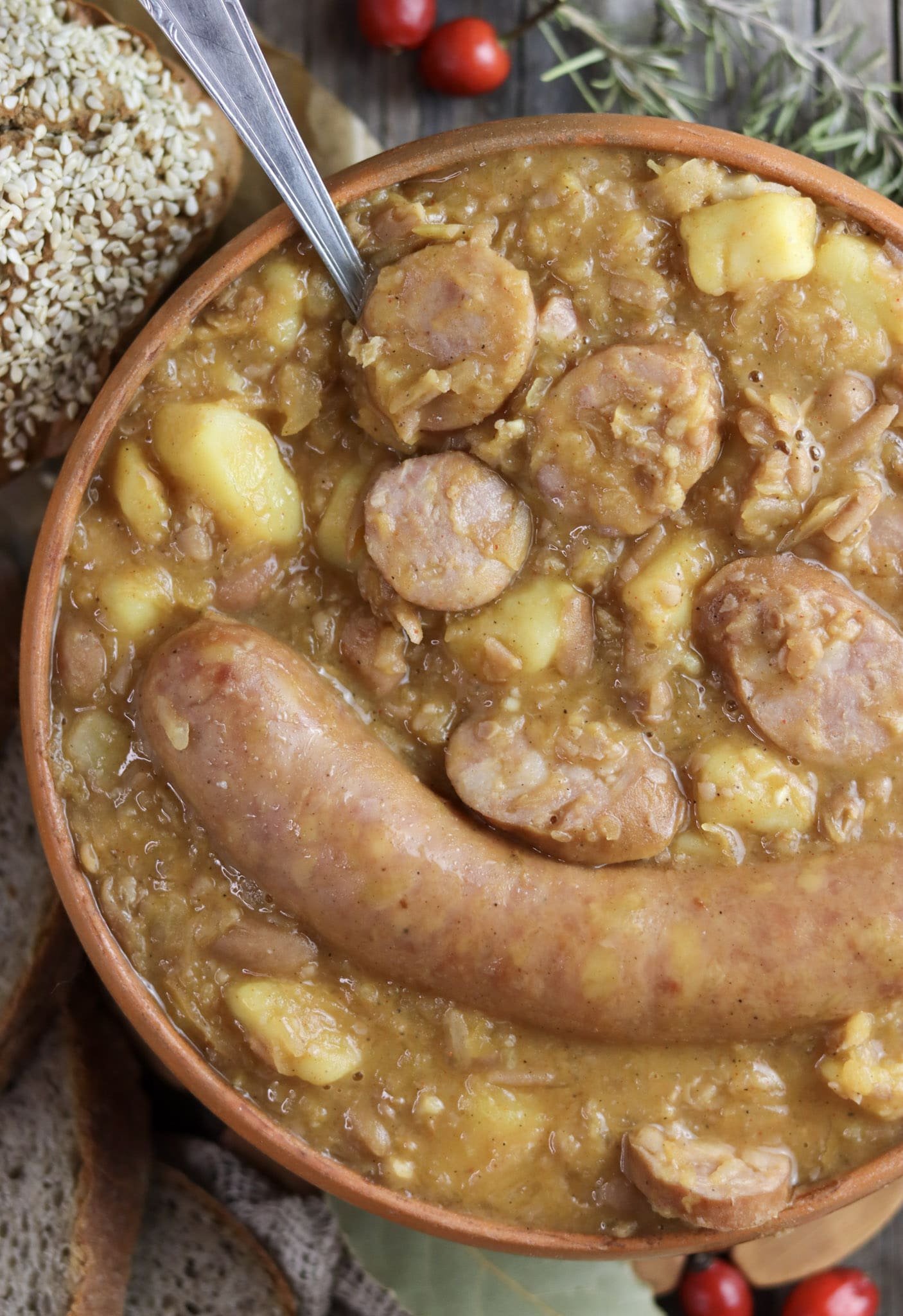 Freshly cooked jota soup with homemade bread in the background.