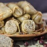 A plate of stuffed sour cabbage rolls with buckwheat and homemade buckwheat bread beside the plate.