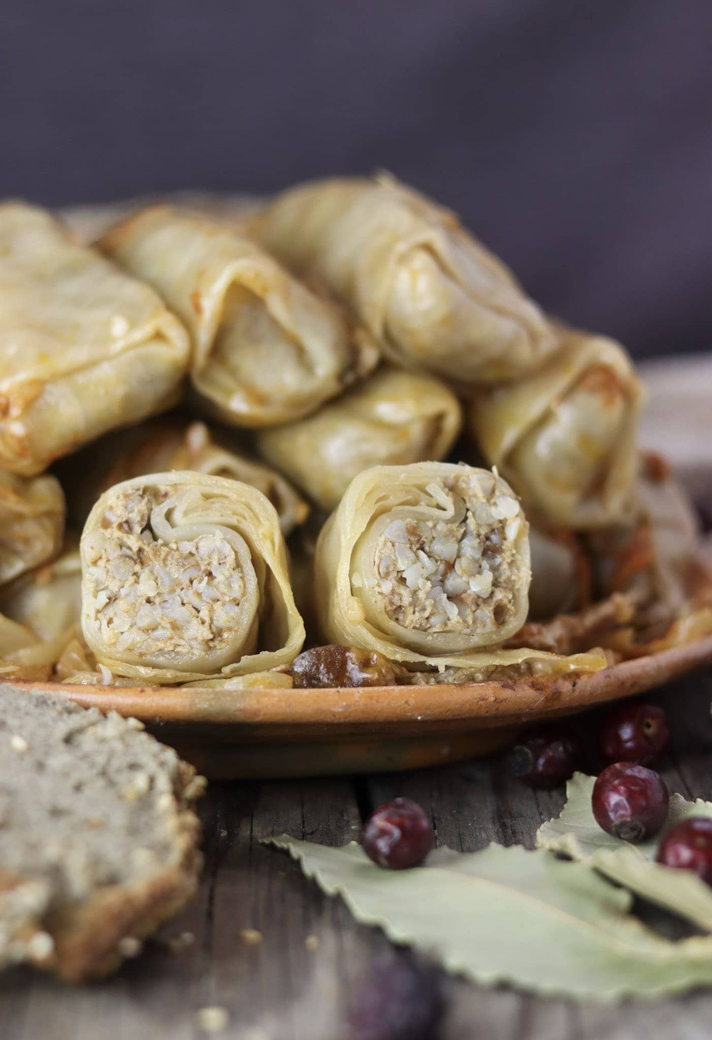 A plate of stuffed sour cabbage rolls with buckwheat and homemade buckwheat bread beside the plate.