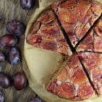 Slices of delicious upside down plum buckwheat cake served on the table.