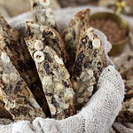 Crispy buckwheat biscotti arranged in a rustic basket