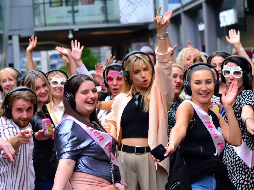 Silent disco party with dancing crowd.