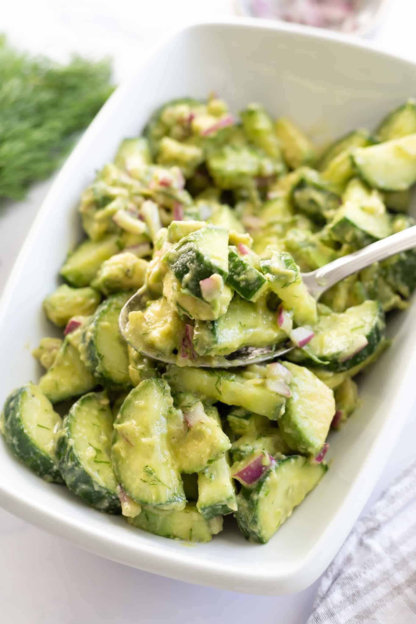 A platter of crunchy cucumber salad with avocado.
