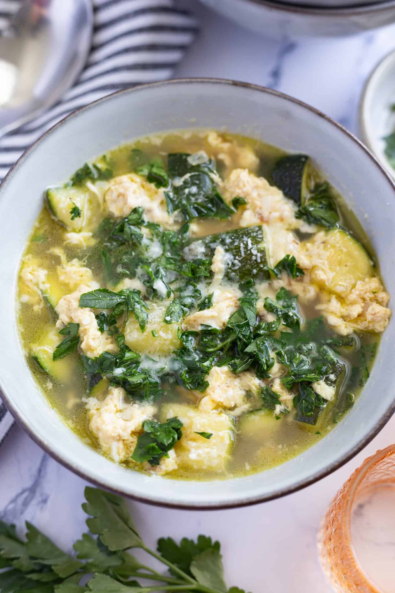 A bowl of Italian zucchini soup with lightly scrambled eggs.