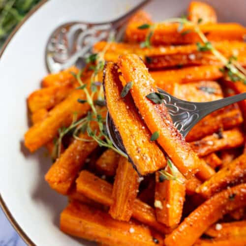 A bowl of easy thyme roasted carrots with Parmesan.