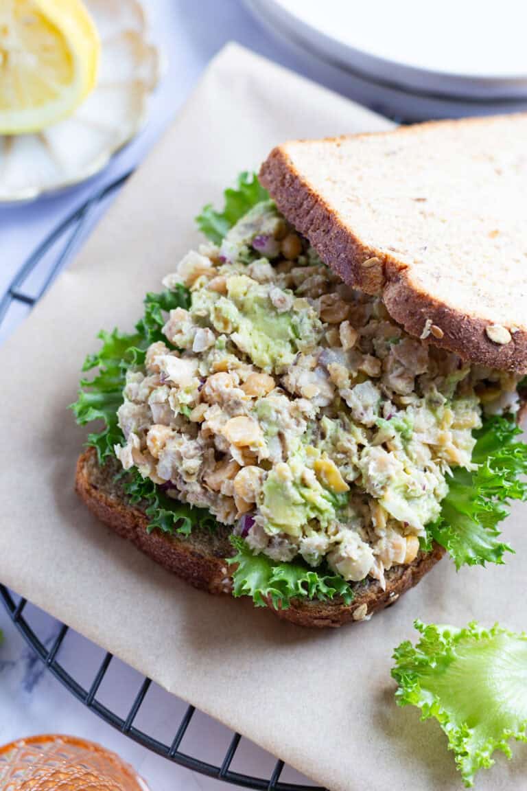 Whole grain sandwich bread topped with sardines, smashed chickpeas, and avocado.