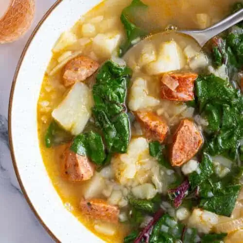 A bowl of cozy Swiss chard soup with chorizo.