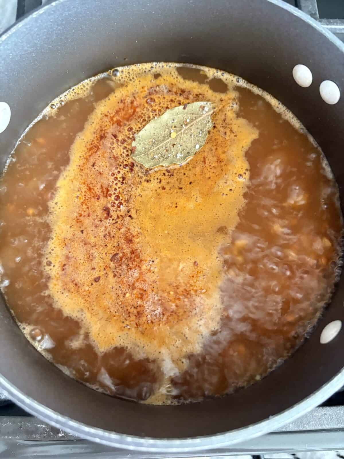 Lentils and other ingredients added to broth.