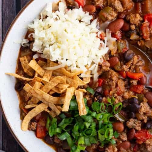 A bowl of spicy turkey chili with beans.