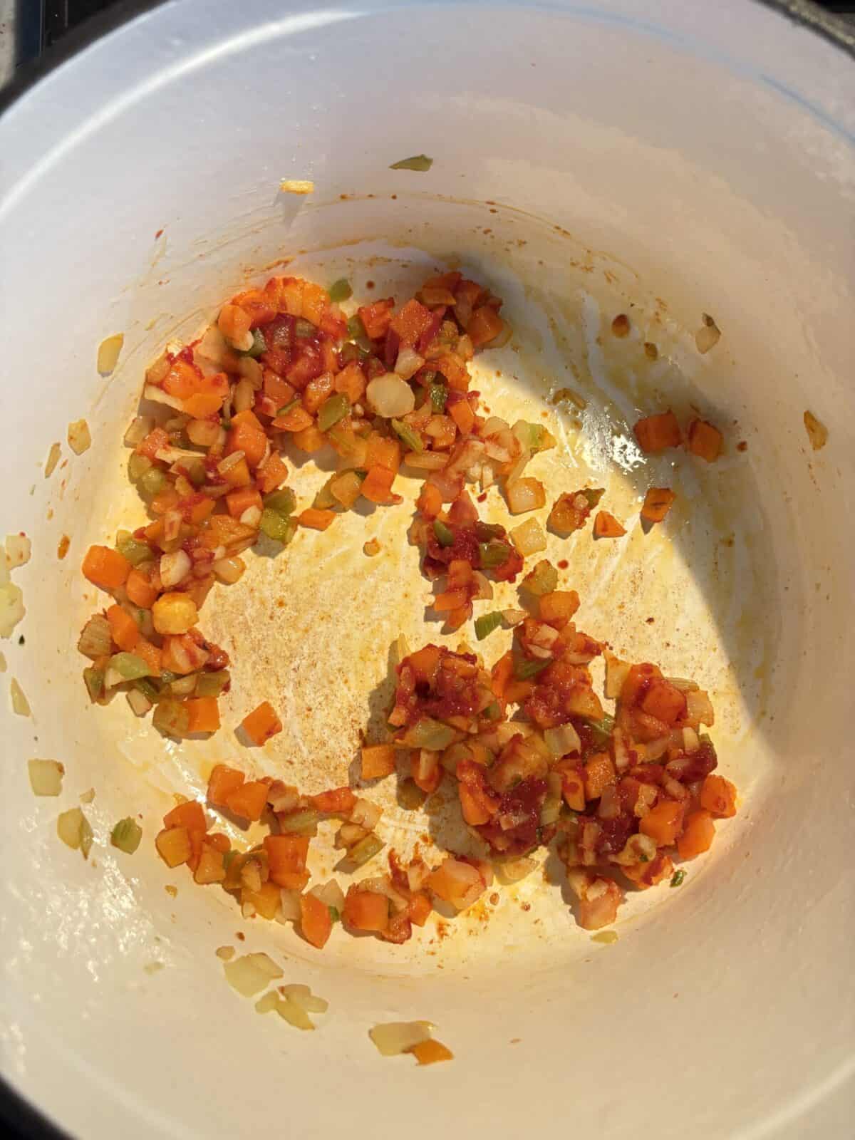 Mirepoix cooked with tomato paste.